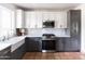 Modern kitchen with white and gray cabinets and tile backsplash at 3715 N 9Th Pl, Phoenix, AZ 85014