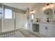 Modern bathroom with double vanity, farmhouse style mirrors, and a walk-in shower at 3740 S 182Nd Ln, Goodyear, AZ 85338