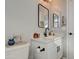 Modern bathroom with white vanity, black fixtures, and a large mirror at 3740 S 182Nd Ln, Goodyear, AZ 85338