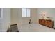 Small bedroom with wood-look flooring and a mid-century modern dresser at 3740 S 182Nd Ln, Goodyear, AZ 85338