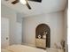 Bedroom with contemporary decor, a ceiling fan, and built-in shelving at 3740 S 182Nd Ln, Goodyear, AZ 85338