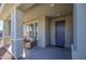 Covered porch with seating area and a dark brown door at 3740 S 182Nd Ln, Goodyear, AZ 85338