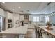 Modern kitchen with white cabinets, island, and stainless steel appliances at 3740 S 182Nd Ln, Goodyear, AZ 85338