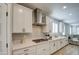 White shaker cabinets, gas cooktop and stainless steel range hood at 3740 S 182Nd Ln, Goodyear, AZ 85338