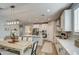 Kitchen features white cabinets, quartz countertops, and an island at 3740 S 182Nd Ln, Goodyear, AZ 85338