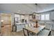 Kitchen features an island, dining area, and white cabinetry at 3740 S 182Nd Ln, Goodyear, AZ 85338