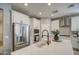 Stainless steel appliances and white shaker cabinets in kitchen at 3740 S 182Nd Ln, Goodyear, AZ 85338