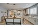 Bright kitchen with white cabinets, large island, and dining area at 3740 S 182Nd Ln, Goodyear, AZ 85338