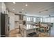 Modern kitchen with white cabinets, island, and stainless steel appliances at 3740 S 182Nd Ln, Goodyear, AZ 85338