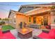 Inviting backyard with fire pit and outdoor kitchen at 3894 E Ebano St, Gilbert, AZ 85295