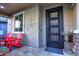 Modern front door with iron security gate and red chairs at 3894 E Ebano St, Gilbert, AZ 85295