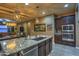 Large kitchen island with granite countertop and stainless steel sink at 3894 E Ebano St, Gilbert, AZ 85295