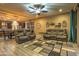 Comfortable living room featuring leather sofas and ceiling fan at 3894 E Ebano St, Gilbert, AZ 85295