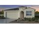 One-story house with tile roof, two-car garage, and desert landscaping at 3988 E Ghost Flower Ln, San Tan Valley, AZ 85140