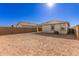 Sunny backyard with a new home and block wall at 40130 W Sunland Dr, Maricopa, AZ 85138