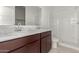 Bathroom with double vanity, marble countertop, and shower at 40130 W Sunland Dr, Maricopa, AZ 85138