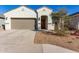 White single-story house with brown garage door and landscaping at 40130 W Sunland Dr, Maricopa, AZ 85138