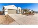 Modern curb appeal, two-car garage, and drought-tolerant landscaping at 40130 W Sunland Dr, Maricopa, AZ 85138