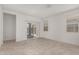 Bright and airy living room with tile floors and sliding glass door at 40130 W Sunland Dr, Maricopa, AZ 85138