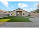 Artificial turf backyard with a gravel area and home view at 40864 W Novak Ln, Maricopa, AZ 85138