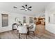 Bright dining room features a round table and chairs, adjacent to the kitchen at 40864 W Novak Ln, Maricopa, AZ 85138