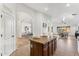 Open kitchen with island, wood cabinets, and tile floors at 40864 W Novak Ln, Maricopa, AZ 85138