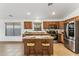 Kitchen with island, stainless steel appliances, and wooden cabinets at 40864 W Novak Ln, Maricopa, AZ 85138