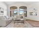 Living room with hardwood floors, large windows, and ample natural light at 40864 W Novak Ln, Maricopa, AZ 85138