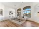 Living room with hardwood floors, large windows and comfy seating at 40864 W Novak Ln, Maricopa, AZ 85138