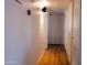 Long hallway with wood floors and light walls at 4320 W Keim Dr, Glendale, AZ 85301