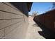 Side yard with brick wall and paved pathway at 4320 W Keim Dr, Glendale, AZ 85301