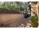 Landscaped backyard with brick patio and wooden fence at 4446 E Camelback Rd # 109, Phoenix, AZ 85018