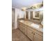 Bathroom with double sinks, granite countertops, and tile shower at 4446 E Camelback Rd # 109, Phoenix, AZ 85018