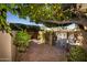 Brick pathway leads to wrought iron gate under a lemon tree at 4446 E Camelback Rd # 109, Phoenix, AZ 85018