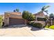 Spanish style home with a large garage and mature landscaping at 4446 E Camelback Rd # 109, Phoenix, AZ 85018