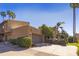 Tan colored stucco home with a garage and palm trees at 4446 E Camelback Rd # 109, Phoenix, AZ 85018