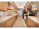 Well-equipped kitchen with light wood cabinets at 4446 E Camelback Rd # 109, Phoenix, AZ 85018