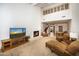 Bright living room with fireplace and lofted ceilings at 4446 E Camelback Rd # 109, Phoenix, AZ 85018