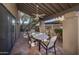 Covered patio with brick flooring and outdoor dining set at 4446 E Camelback Rd # 109, Phoenix, AZ 85018