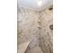 Walk-in shower with neutral tile and built-in shelving at 4446 E Camelback Rd # 109, Phoenix, AZ 85018