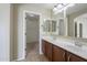 Bathroom with double sinks, large mirror, and walk-in closet at 44865 W Horse Mesa Rd, Maricopa, AZ 85139