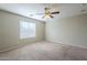 Bright bedroom with window, ceiling fan, and neutral decor at 44865 W Horse Mesa Rd, Maricopa, AZ 85139