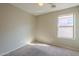 Bright bedroom featuring a window with blinds and ceiling fan at 44865 W Horse Mesa Rd, Maricopa, AZ 85139