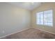 Simple bedroom with neutral walls and carpeted floor at 44865 W Horse Mesa Rd, Maricopa, AZ 85139