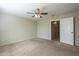 Primary bedroom with ceiling fan and door to bathroom at 44865 W Horse Mesa Rd, Maricopa, AZ 85139