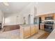 Kitchen with island, hardwood floors, and fireplace view at 4601 E Peak View Rd, Cave Creek, AZ 85331