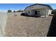 Large backyard with gravel and a covered patio at 4744 W Orange Ave, Coolidge, AZ 85128