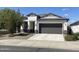 Single-story home with a two-car garage and desert landscaping at 4744 W Orange Ave, Coolidge, AZ 85128