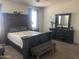 Spacious main bedroom with large bed, dresser, and bench at 4744 W Orange Ave, Coolidge, AZ 85128