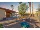 Large backyard with seating area, pool view, and sand play area at 4944 E Windrose Dr, Scottsdale, AZ 85254